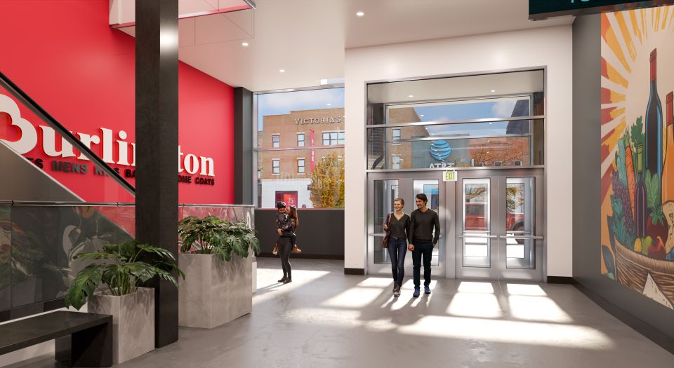 A modern store entrance with a red Burlington sign, potted plants, and a colorful mural. People are entering and exiting through glass doors.
