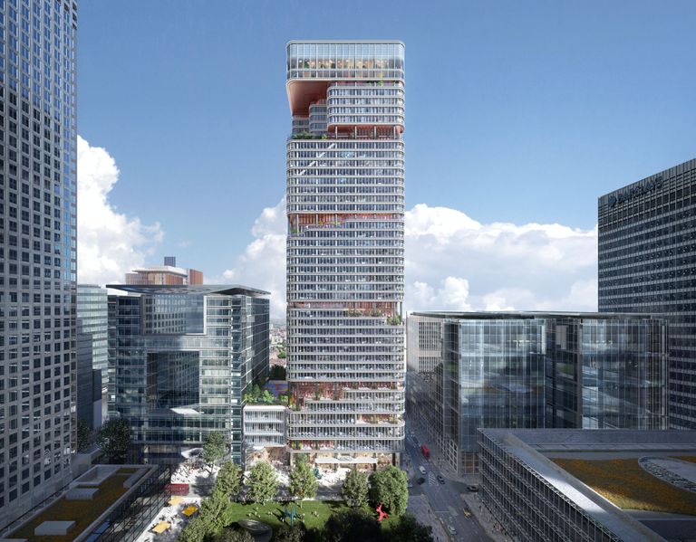 A modern cityscape with a tall, sleek skyscraper featuring curved balconies and adjacent contemporary glass buildings under a clear blue sky.