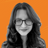 Woman with long hair and glasses, smiling, on an orange background.
