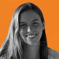 Smiling woman with long hair in a grayscale photo against an orange background with subtle wave patterns.