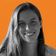 Smiling woman with long hair in a grayscale photo against an orange background with subtle wave patterns.