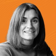 Smiling woman with shoulder-length hair, wearing a sweater, against an orange background with wavy patterns.