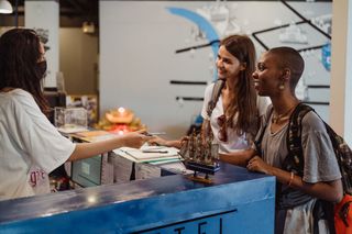 Two people checking into a hotel.