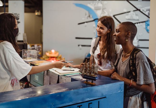 Two people checking into a hotel.