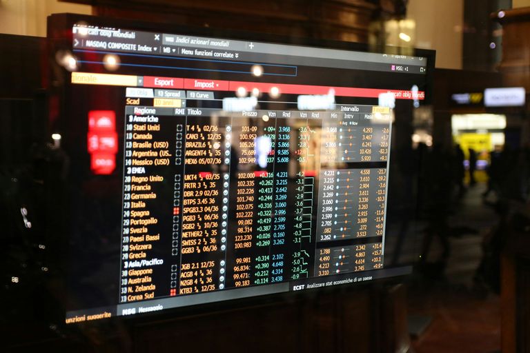A digital screen displaying a stock market board with various financial data, including company names, indices, and numerical values.