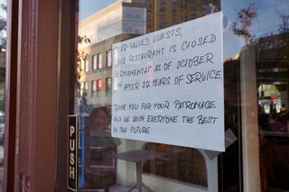 Sign on restaurant door announcing permanent closure after 22 years of service, thanking patrons and wishing them well for the future.
