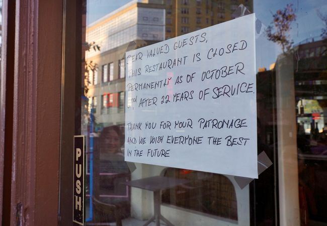 Sign on restaurant door announcing permanent closure after 22 years of service, thanking patrons and wishing them well for the future.