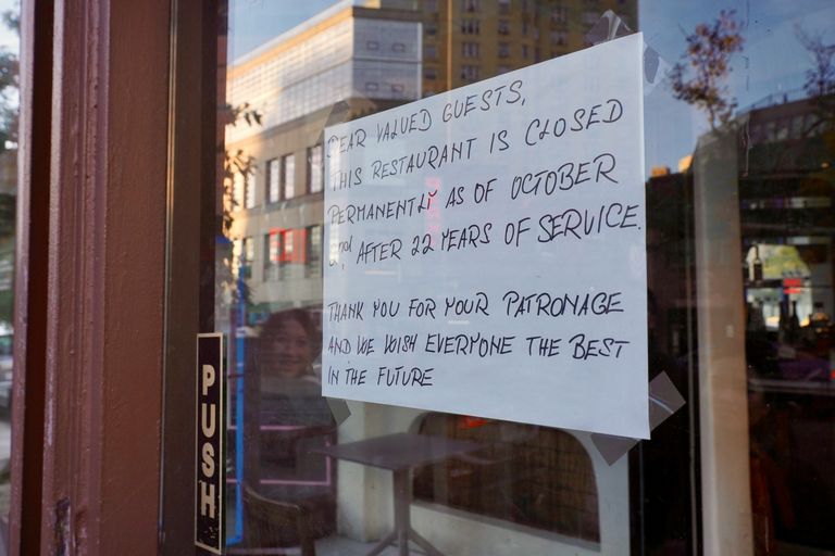 Sign on restaurant door announcing permanent closure after 22 years of service, thanking patrons and wishing them well for the future.