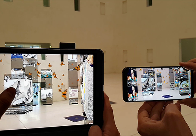 People looking at a building through augmented reality