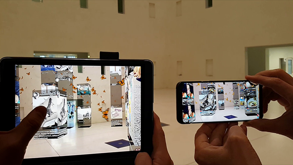 People looking at a building through augmented reality