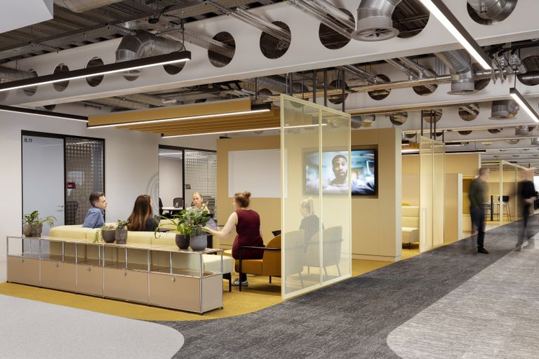 A photo of a workplace with yellow walls and a grey floor