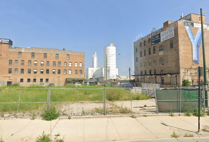 Vacant lot between two old factory buildings in Chicago.