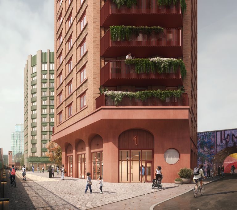 Street view of a modern brick apartment building with plant-filled balconies and people walking or cycling nearby.