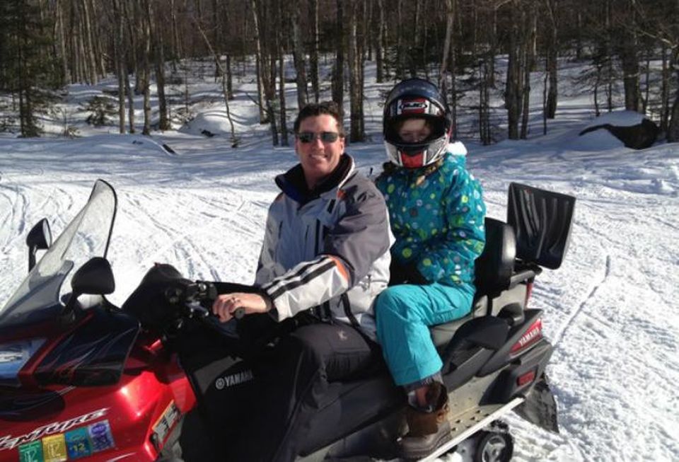 Chip Walters, snowmobiling with his daughter