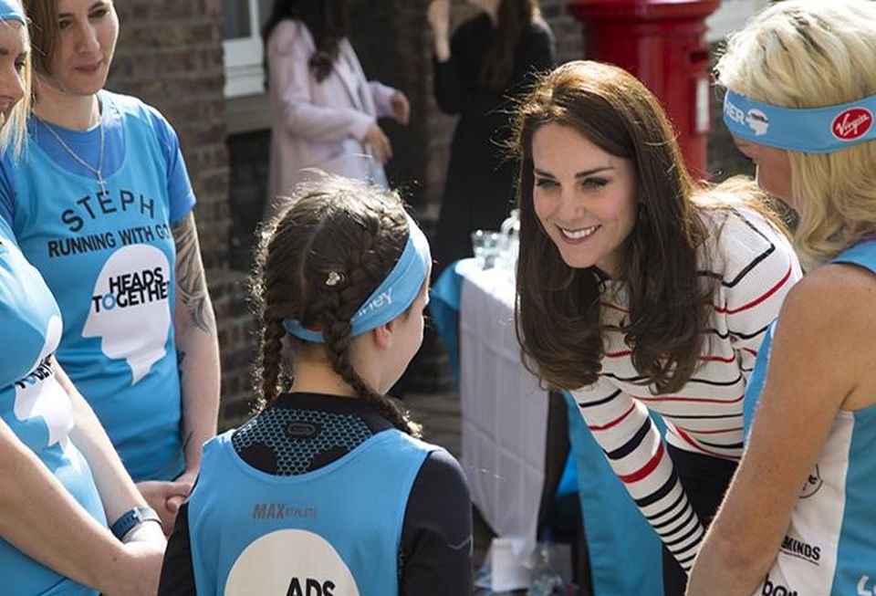 The Duchess of Cambridge talks with a young runner
