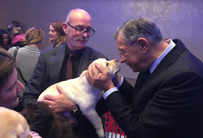 Sir George Iacobescu with a puppy 