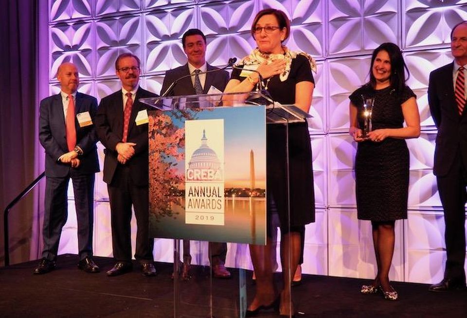Brandywine Realty Trust's Janet Davis accepting the Brendan McCarthy Memorial Award, with past winners behind her