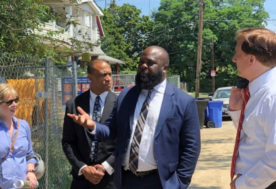 White House Opportunity and Revitalization Council Executive Director Scott Turner, Deputy Assistant to the President Ja'Ron Smith, and Assistant Secretary of Commerce for Economic Development John Fleming taking a tour of an OZ project in the Tremont neighborhood of Cleveland in 2019.