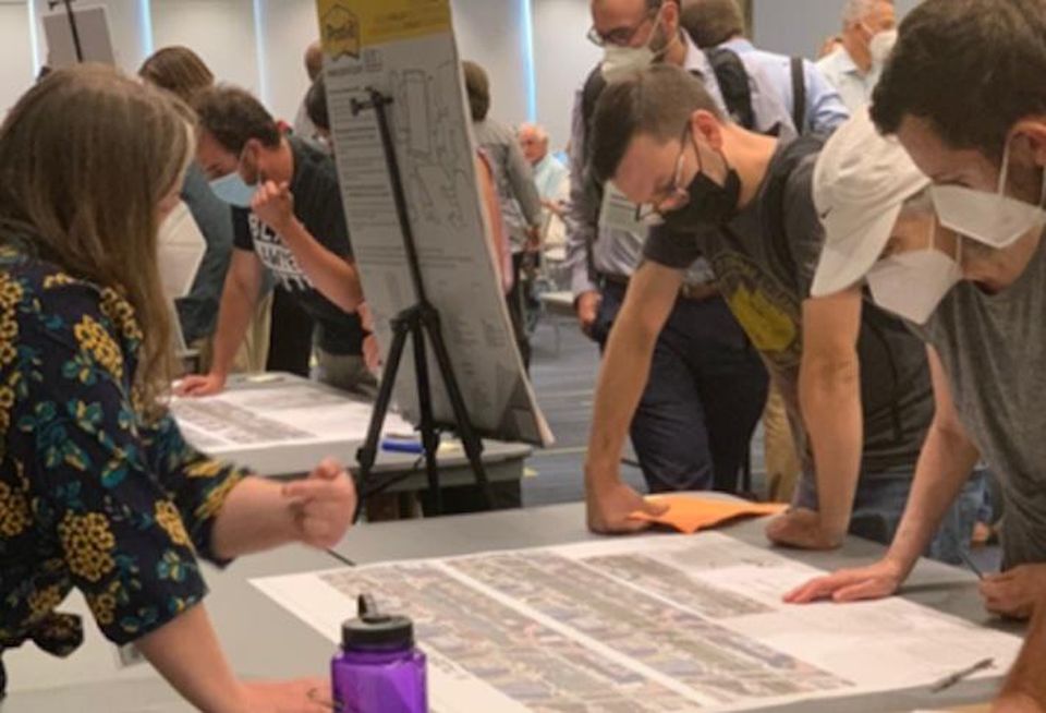 Residents review plans at a D.C. Department of Transportation public meeting on the Connecticut Avenue bike lane plan in June 2022.