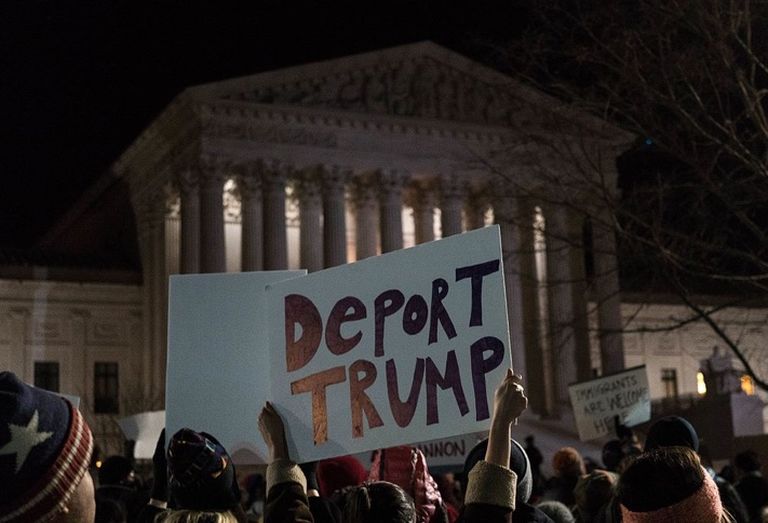 Deport Trump sign at Supreme Court news conference to call for a reversal of President Trump’s travel ban on refugees and immigrants in February