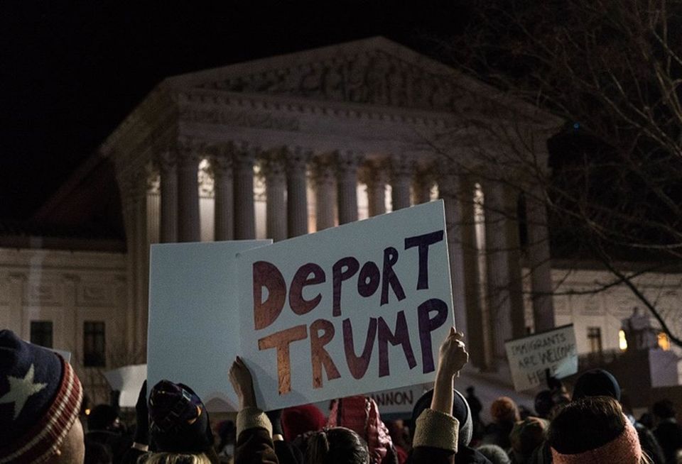 Deport Trump sign at Supreme Court news conference to call for a reversal of President Trump’s travel ban on refugees and immigrants in February