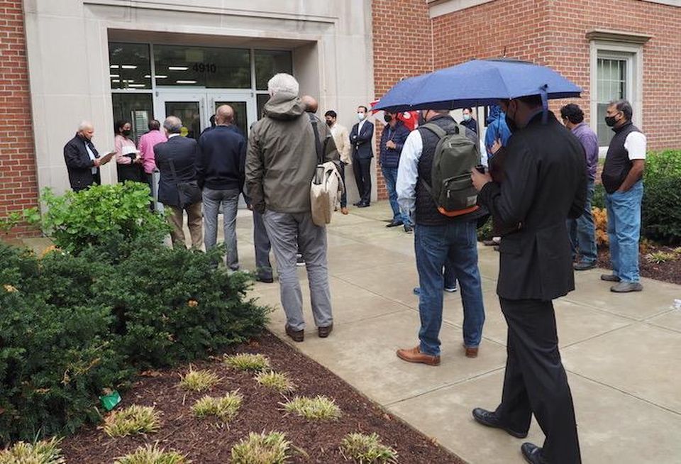 The auction for the Oak Hill Apartments, held Wednesday morning outside the entrance of 4910 Massachusetts Ave. NW.