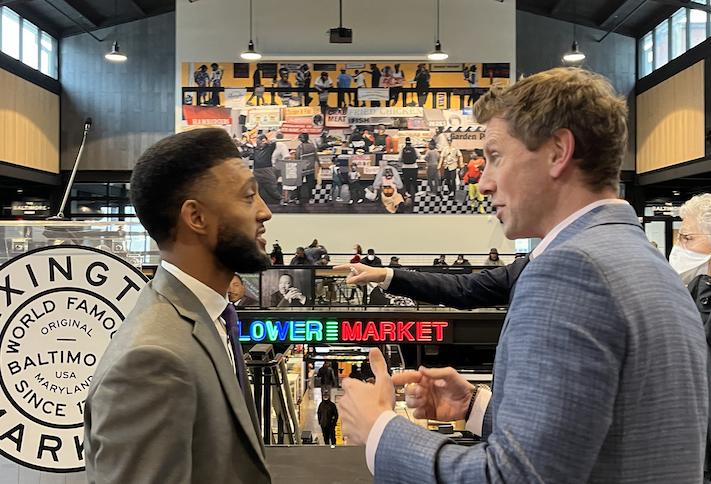 Baltimore Mayor Brandon Scott speaks with Seawall Development Principal Thibault Manekin during the ceremonial opening of the new Lexington Market building.
