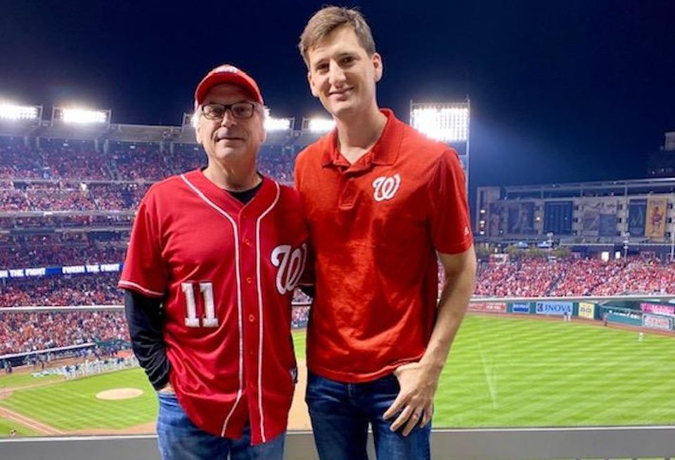 Melnick Real Estate Advisors' Jesse Mates (right) at World Series Game 3 with his father