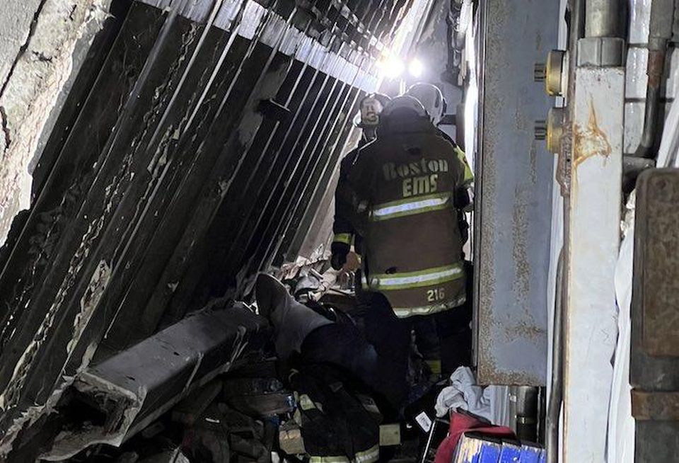 A Boston EMS worker on the site of the Boston Edison power plant after Wednesday's partial building collapse.