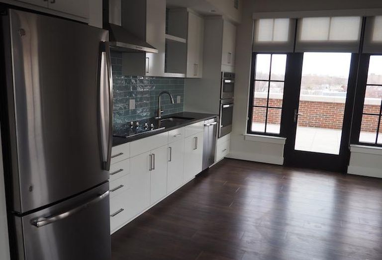 The kitchen and door to the private terrace in a fifth-floor two-bedroom unit in the Avec building. 