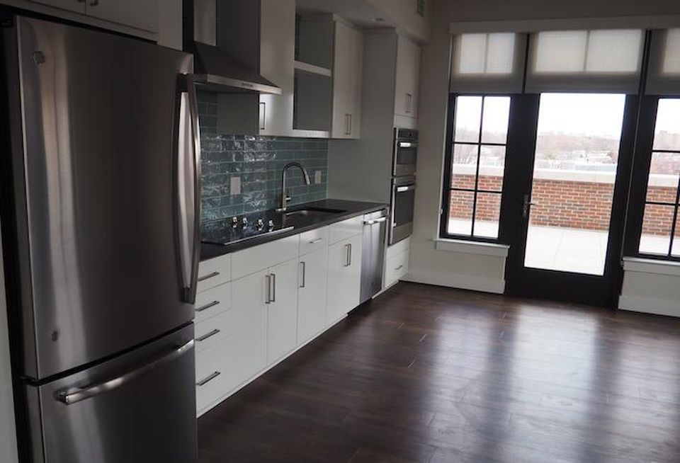 The kitchen and door to the private terrace in a fifth-floor two-bedroom unit in the Avec building.