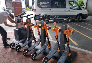 An electric scooter docking station with Spin scooters