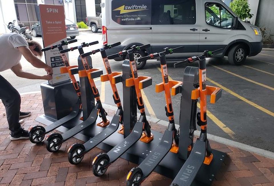 An electric scooter docking station with Spin scooters