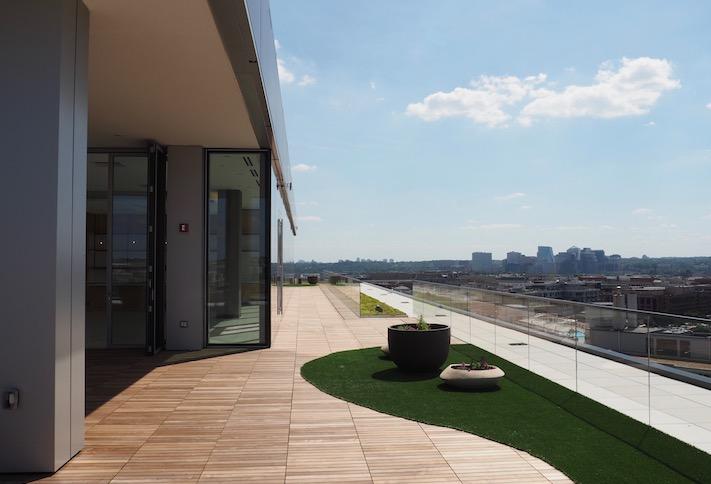 The rooftop amenity space at Meridian Group's 1333 New Hampshire Ave. NW, with a view of Rosslyn. 