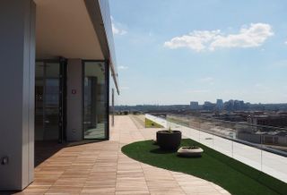The rooftop amenity space at Meridian Group's 1333 New Hampshire Ave. NW, with a view of Rosslyn. 