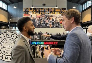 Baltimore Mayor Brandon Scott speaks with Seawall Development Principal Thibault Manekin during the ceremonial opening of the new Lexington Market building.
