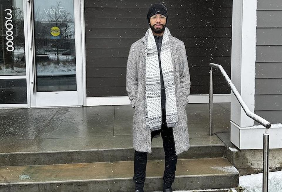 Kai Palmer-Dunning standing outside of his apartment building in Jamaica Plain, where he waited more than a year to move into an affordable unit after starting the application process.