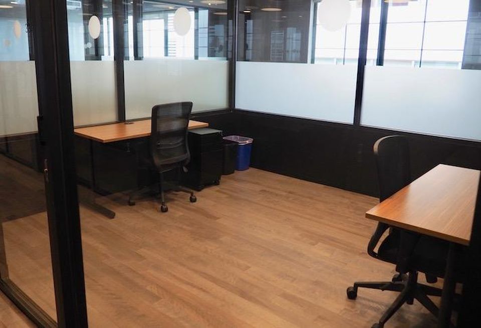 A private office, which previously had four desks but was reduced to two, in coworking space The Mark.