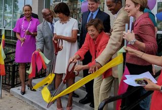 Telesis Corp. President Marilyn Melkonian cutting the ribbon on a project in Baltimore. 