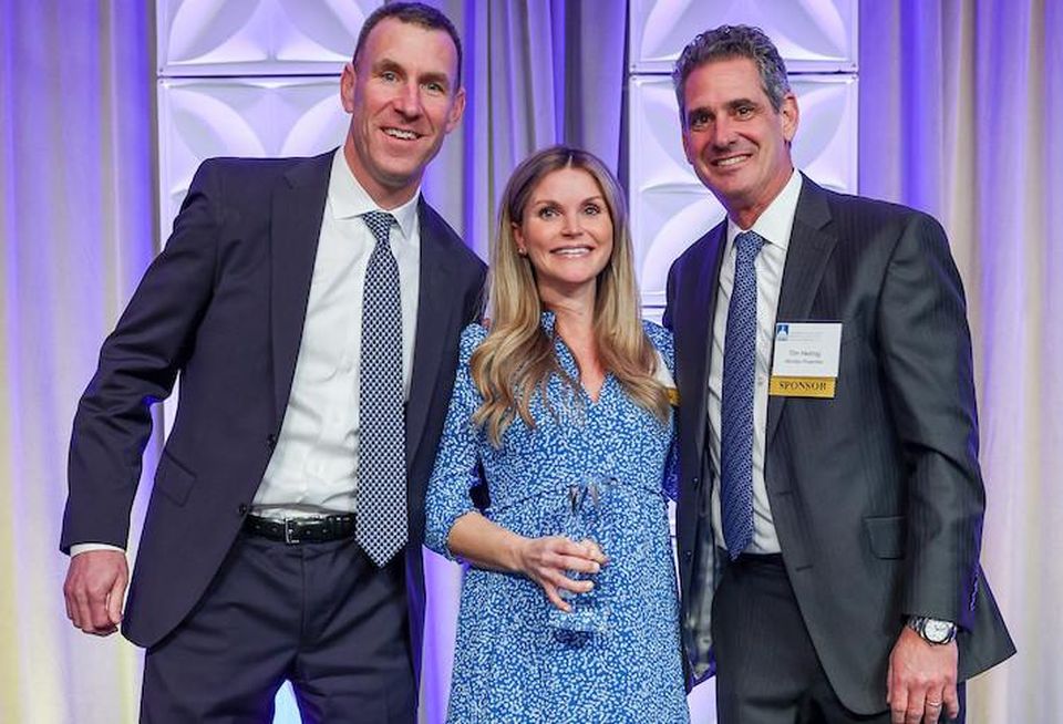 BXP's Erin Cotter accepting the Rising Star Award, along with BXP's Jake Stroman and Monday Properties' Tim Helmig.