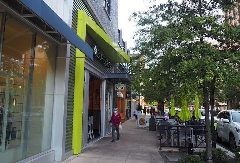 People walking and dining outside at the Pike & Rose development. 