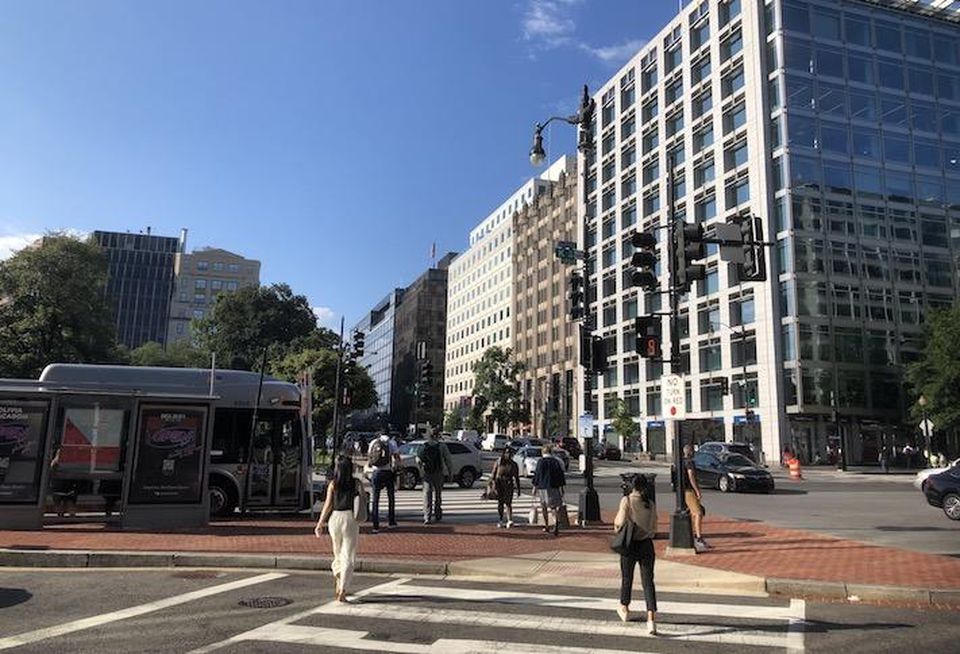 Pedestrians crossing Downtown D.C's 17th and K street NW intersection Tuesday morning.