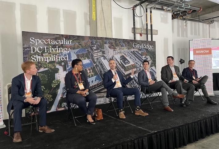 EYA’s McLean Quinn, D.C. Office of Planning Interim Director Anita Cozart, Roadside’s Robert Wolcheski, Tishman Speyer’s Jeff Chod, Donohoe Cos.’s Jad Donohoe, Shalom Baranes Associates’ Robert M. Sponseller speak during a panel at Bisnow’s Northwest D.C. event on June 2, 2022.