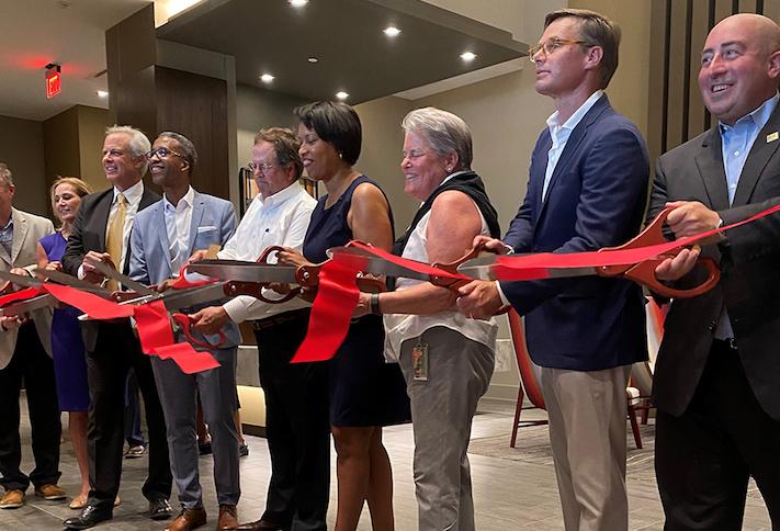 The Rappaport and WC Smith development team, joined by Mayor Muriel Bowser and other local officials, cutting the ribbon on Skyland Town Center's first residential building. 