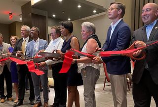 The Rappaport and WC Smith development team, joined by Mayor Muriel Bowser and other local officials, cutting the ribbon on Skyland Town Center's first residential building. 