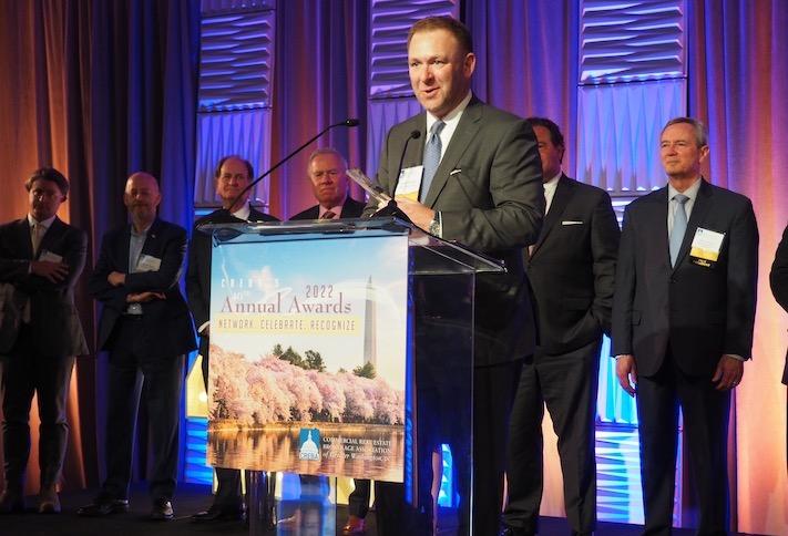 Stream Realty's Andy Eichberg, this year's winner of CREBA's Brendan McCarthy Memorial Award, flanked by past winners of the award. 