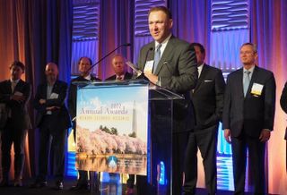 Stream Realty's Andy Eichberg, this year's winner of CREBA's Brendan McCarthy Memorial Award, flanked by past winners of the award. 