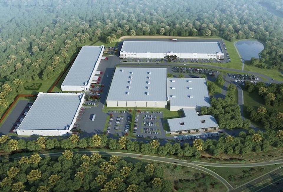 A rendering of the Hargrove Industrial Campus, with the three new buildings around the edge of the existing warehouse