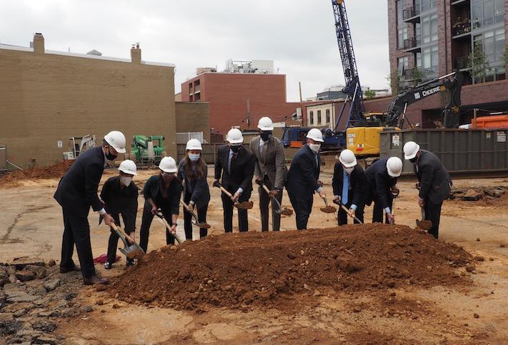 Members of the development team and local officials celebrating the groundbreaking of the condo project at 8th and O streets NW in Shaw. 