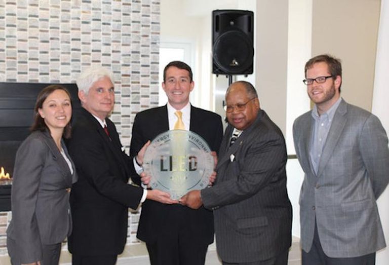 Fore Property Co.'s Jim Sullivan (center) accepting a LEED certification plaque